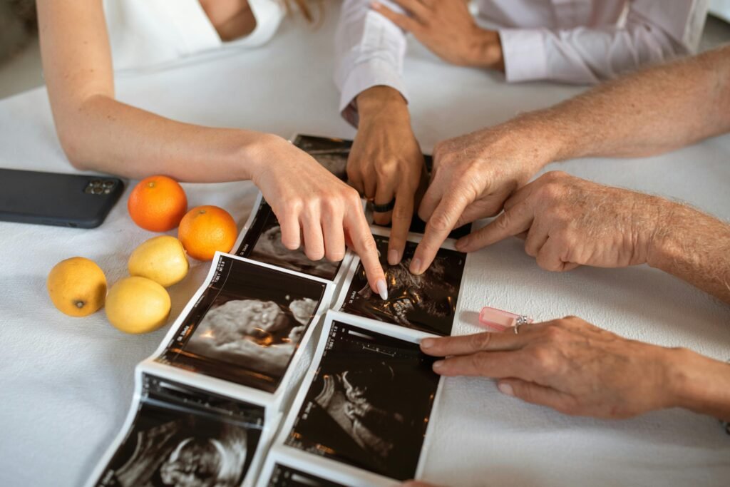 Family members gathered around ultrasound scans, joyful and supportive during pregnancy announcement.